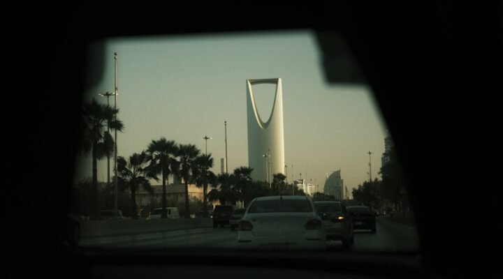 Gulf city skyline with skyscrapers, palm trees and traffic